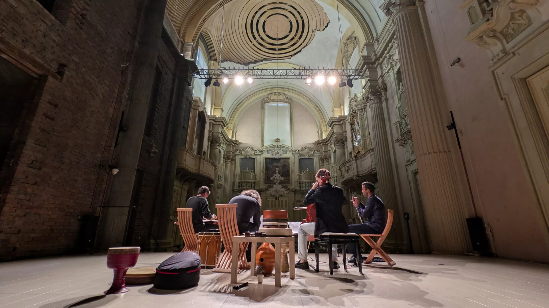 Quartetto di musicisti visti da dietro mentre suonano sul palco dell'Oratorio di San Filippo neri